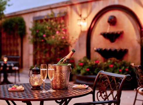 bottle of champagne on a table in the courtyard